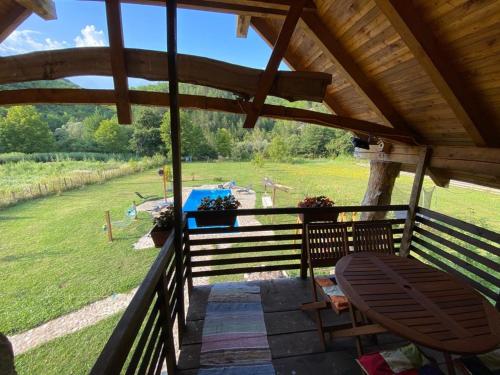a view from the porch of a cabin with a view of a field at Exo Log Cottage in Jezero