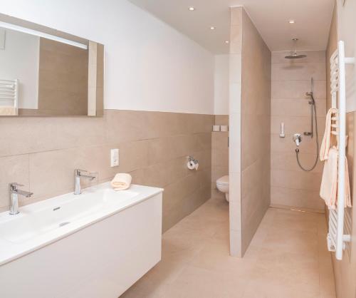 a bathroom with a sink and a toilet at Hotel Restaurant Platzwirt in Rauris