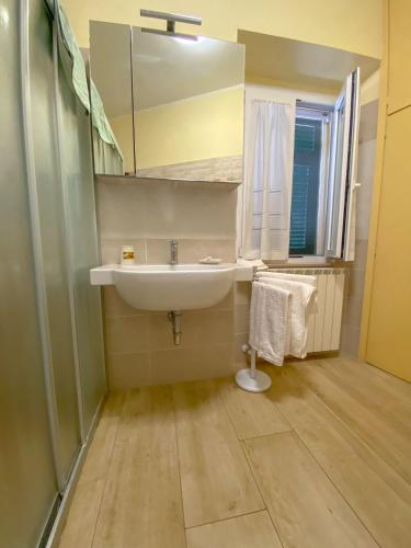 a bathroom with a sink and a mirror at Casa La Marinella in Porto Santo Stefano