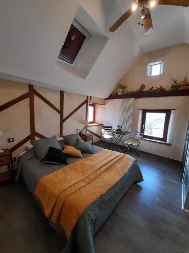 a bedroom with a large bed in a room at Les Hôtes du Lac, Chambres et tables d'hôtes in Mandailles