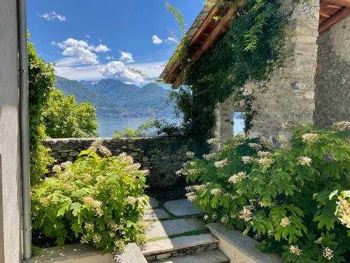 a stone house with a stairway with flowers at Casa Olea Hotel in Cremia