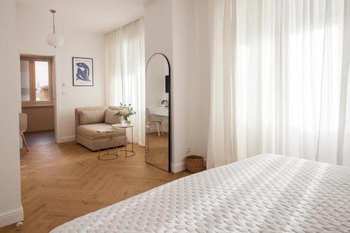 a bedroom with a bed and a mirror and a chair at Aurum D in Split