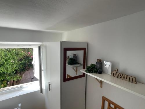 a white room with a mirror and a window at Apartment Chillout House Novalja in Novalja