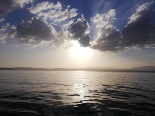 a view of the sun setting over a body of water at B&B Rosalu - Adults Only in Sirmione