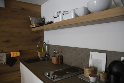 a kitchen with a sink and a counter top at 32 BnB Camerecaffè in Pavia