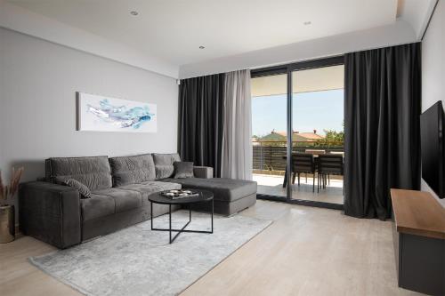 a living room with a couch and a table at Boutique Apartments Kristo in Medulin
