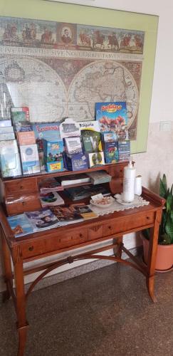 a wooden table with books on top of it at Hotel Margherita Meublè in Sirmione