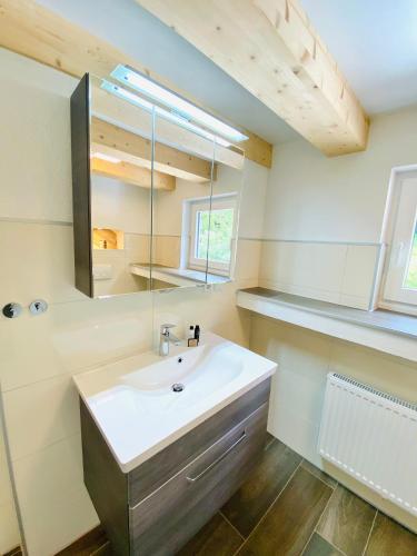 a bathroom with a sink and a mirror at Landhotel Edersee in Waldeck