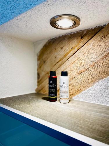 two bottles of paint sitting on a shelf at Landhotel Edersee in Waldeck