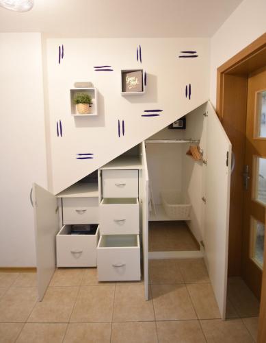 a room with stairs with drawers and cabinets at Apartment Bc in Bovec