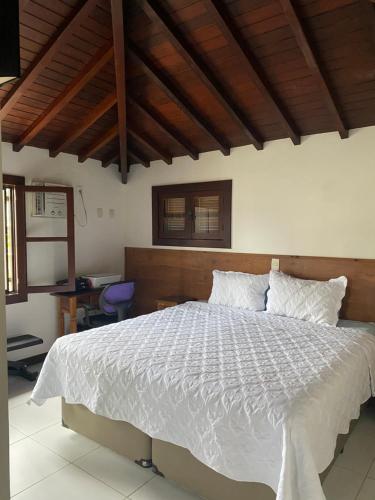 En eller flere senge i et værelse på Casa de praia Família Ramos