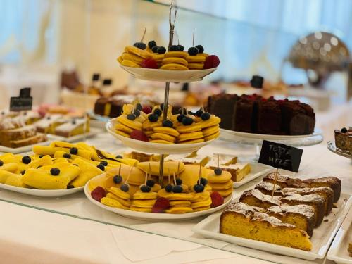 a display of different types of cakes and other desserts at Mansarda Cannes in Riccione
