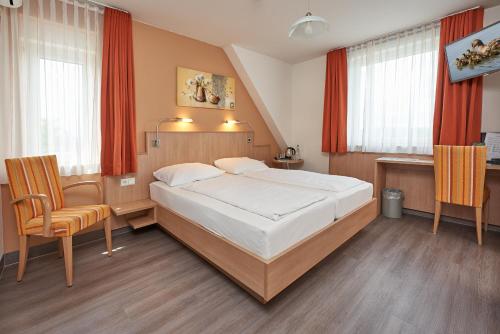 Ένα ή περισσότερα κρεβάτια σε δωμάτιο στο Hotel Touristik