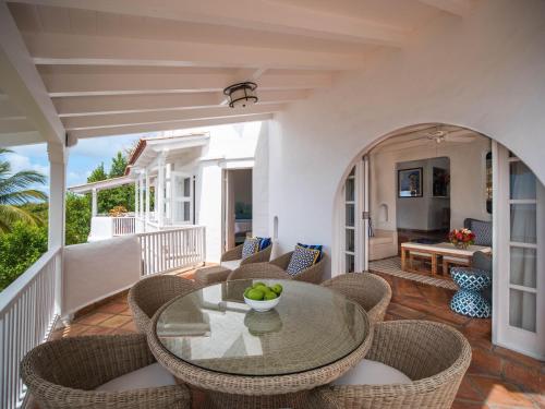 a patio with a table and chairs on a balcony at Windjammer Landing Resort and Residences in Gros Islet