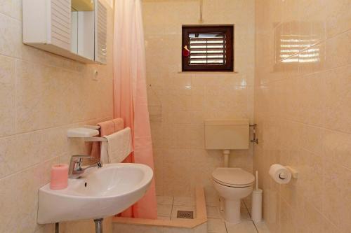 a bathroom with a sink and a toilet at Apartmani Doro in Vela Luka