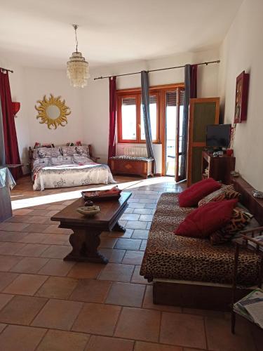 a living room with a bed and a coffee table at Casa Vacanze Monte Argentario in Porto Santo Stefano