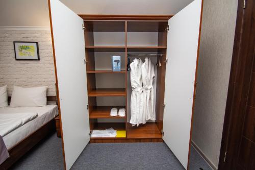a room with a bed and a closet at Три Сімки in Vyshhorod