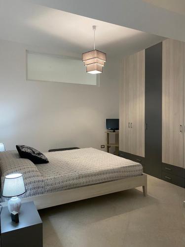 a bedroom with a bed and a pendant light at Momenti e Monumenti in Palermo