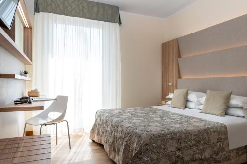 מיטה או מיטות בחדר ב-Hotel Rondinella e Viola