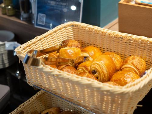 a basket filled with lots of donuts in at Kyriad Hotel Clermont Ferrand Centre in Clermont-Ferrand