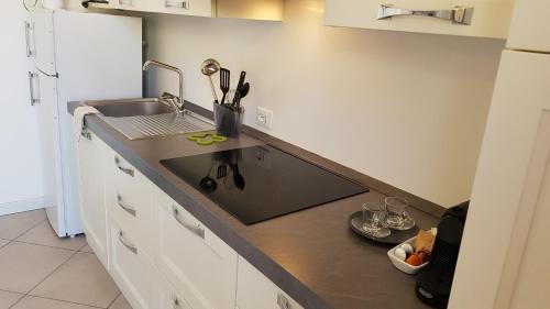 a kitchen with a sink and a counter top at Ex Convento Santa Caterina in Angera