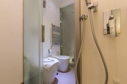 a bathroom with a toilet and a sink and a shower at Residenza Amblingh in Vasto