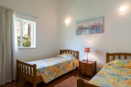 um quarto com 2 camas e uma janela em Villa Macuti by SAPvillas em Vilamoura