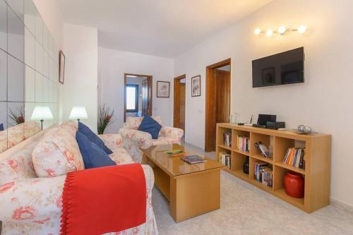a living room with a couch and a tv at Casa Gasparini in Tahiche