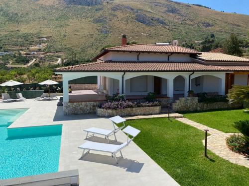 a villa with a swimming pool and a house at Villa Cycas Costamante in Castellammare del Golfo