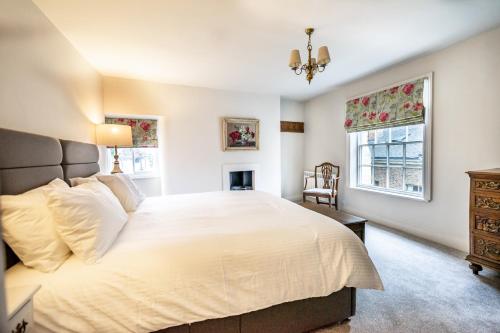 a bedroom with a large white bed and a window at Number One High Petergate in York