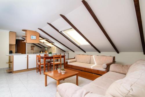 a living room with a couch and a table at SunBliss Studios & Apartments in Alykes