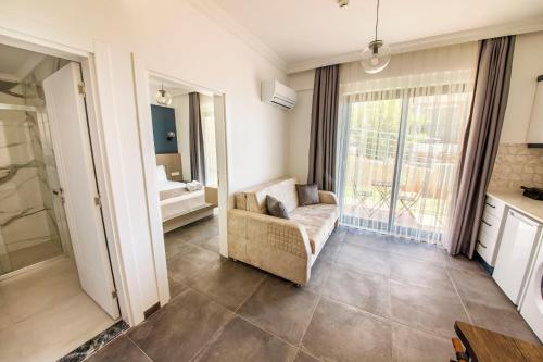 a living room with a couch and a window at Granda Lambuka Apart in Kas