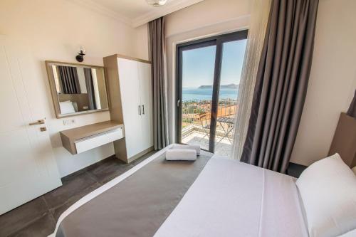 a hotel room with a bed and a large window at Granda Lambuka Apart in Kas
