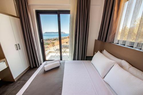 a hotel room with a bed and a large window at Granda Lambuka Apart in Kas