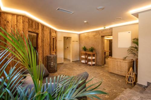 a large room with wooden walls and plants at Hotel Hochfilzer in Ellmau