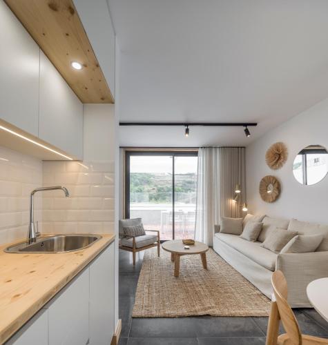 a kitchen and living room with a couch and a table at Ericeira Prime Villas in Ericeira
