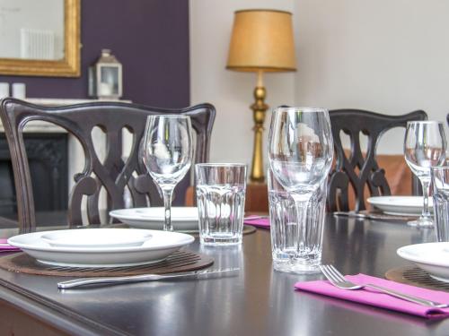 a table with glasses and plates and napkins on it at 3 Berkeley Square Guesthouse in Bristol