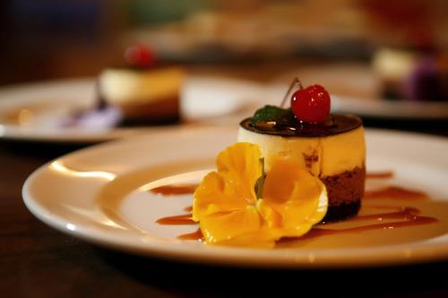a piece of cake with a cherry on top on a plate at Mongena Private Game Lodge in Rust de Winter
