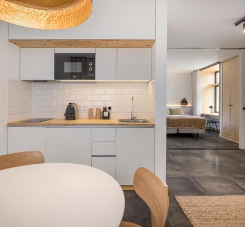 a kitchen with white cabinets and a counter top at Ericeira Prime Villas in Ericeira