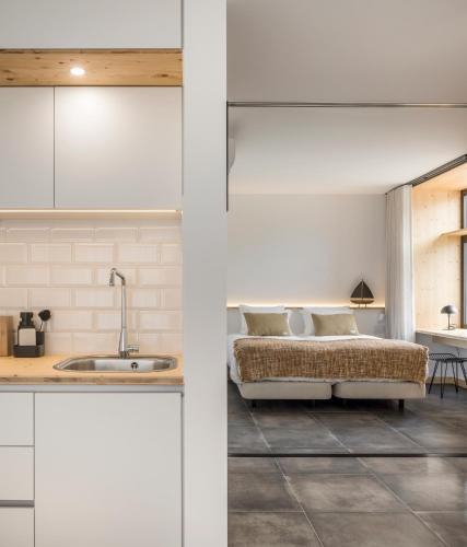 a kitchen with a sink and a bed in a room at Ericeira Prime Villas in Ericeira
