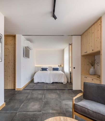 a bedroom with a bed and a couch at Ericeira Prime Villas in Ericeira