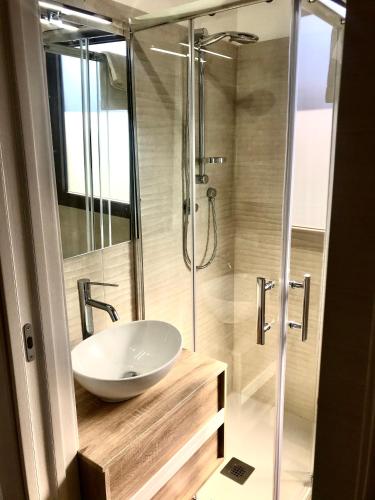 a bathroom with a sink and a shower at Agricampeggio Verde Etna in Aci SantʼAntonio