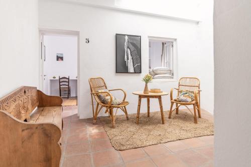 a living room with two chairs and a table at Eole Tarifa Rooms in Tarifa