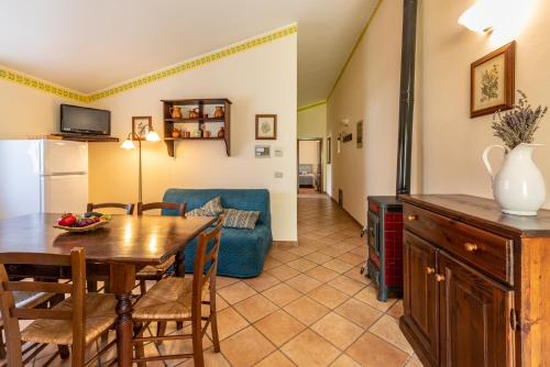 a kitchen and living room with a table and a couch at Agriturismo La Fonte in Bevagna