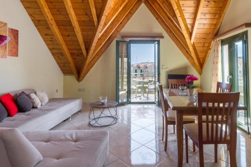 a living room with a couch and a table at Una Bella Mansarda in Argostoli