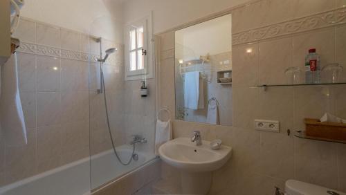 a bathroom with a sink and a shower at Hotel-Restaurant Le Moulin De La Camandoule in Fayence