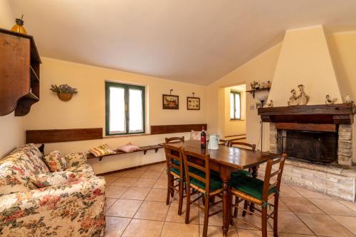 a living room with a table and a couch at Agriturismo La Fonte in Bevagna