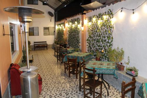 a restaurant with tables and chairs in a room at KAARO HOUSE CUSCO in Cusco