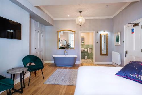 a bedroom with a bed and a bathroom with a tub at Eight in Bath