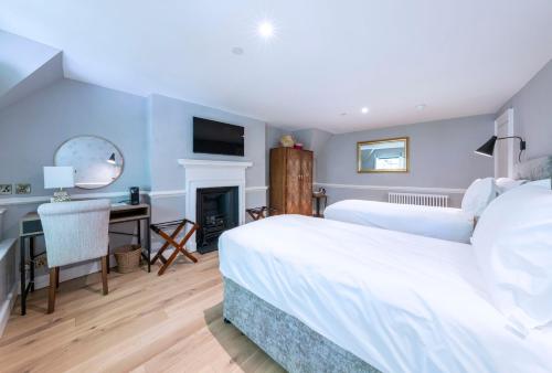 a bedroom with two beds and a desk with a computer at Eight in Bath